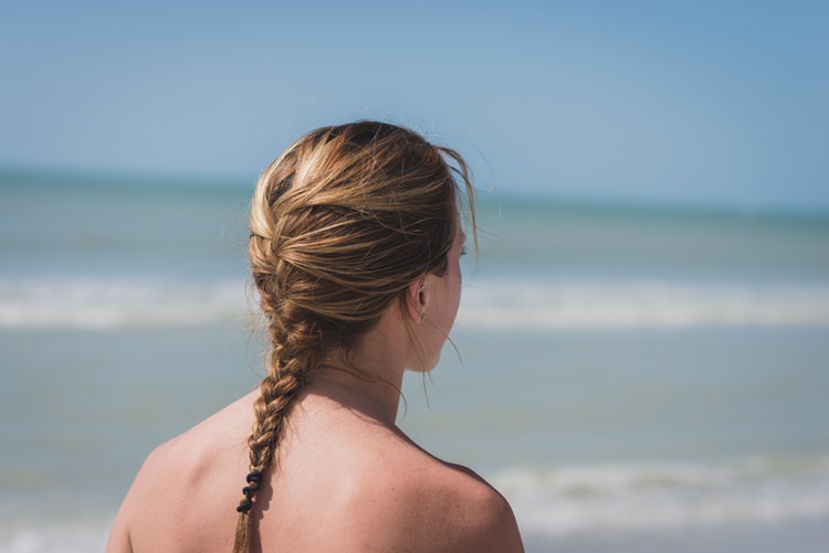 Woman in fishtail braid while walking around the beach